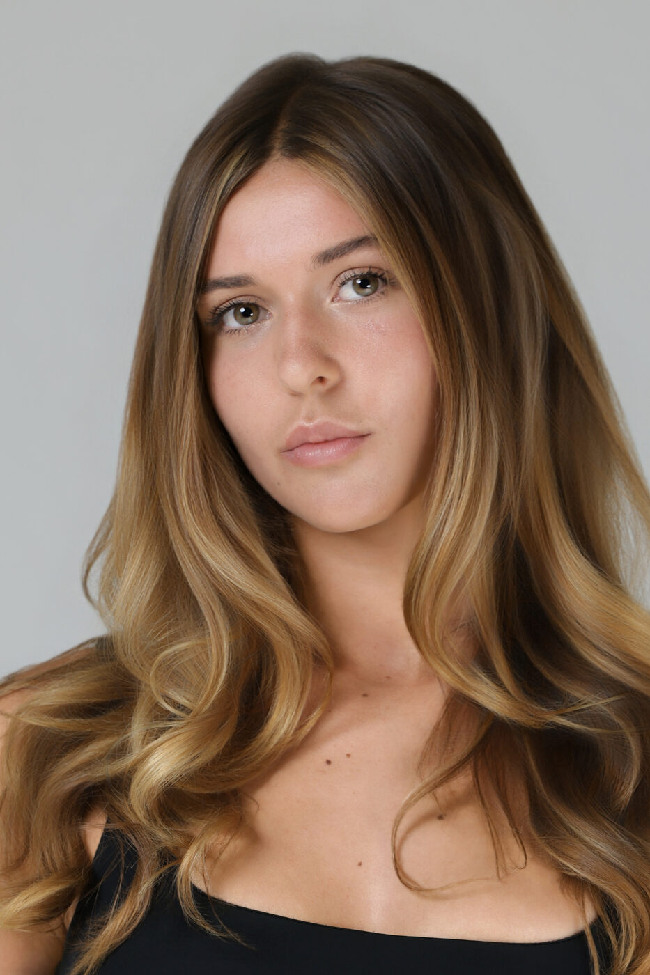 Clean model headshot for a comp card with even studio lighting